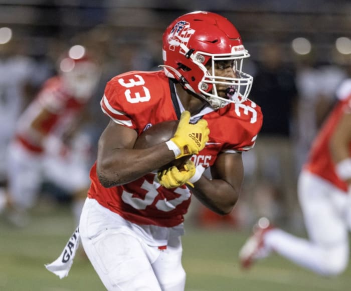 Karson Cox with both hands securing the ball during a recent game. He's rushed for more than 900 yards and 11 touchdowns. Photo: Courtesy of Karson Cox
